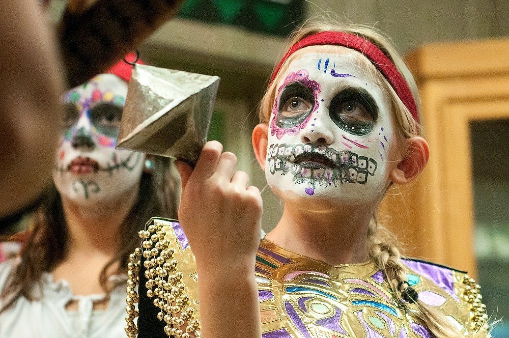 East Lansing resident Mexica Torrez-Miner, 10, participates in a Danza Azteca performance on Thursday, Nov. 1, 2012, at the MSU Museum. The traditional Aztec dance was one of many events held to celebrate Día de los Muertos. James Ristau/The State News