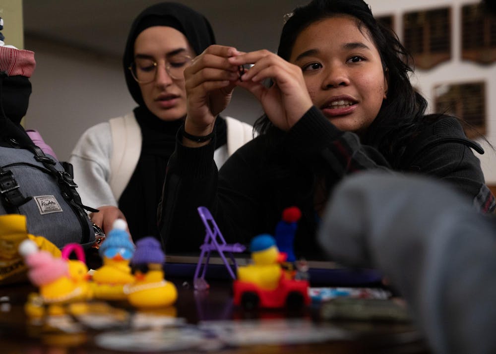 Michigan State psychology junior Ola Turkey, left, and English-humanities prelaw sophomore Audrey Pocopio play with rubber ducks at the student union during the Alcohol and Other Drugs Program's Farewell to the Flock event on Dec. 2, 2024.