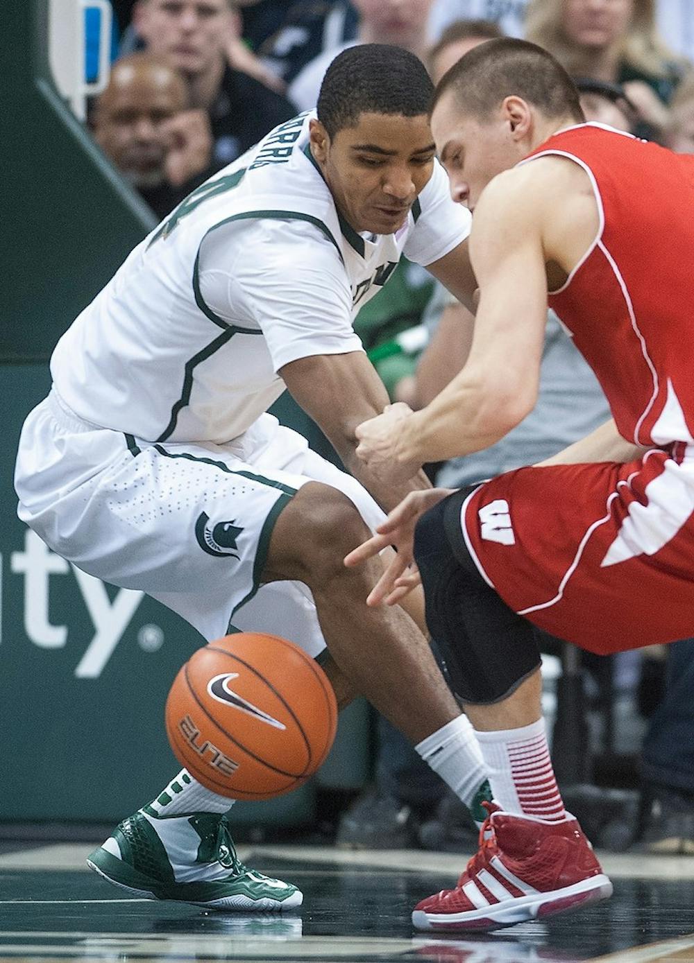 Freshman guard Gary Harris fights for a loose ball with Wisconsin guard Ben Brust at the first half of the game, Thursday, March 7, 2013, at Breslin Center. Justin Wan/The State News