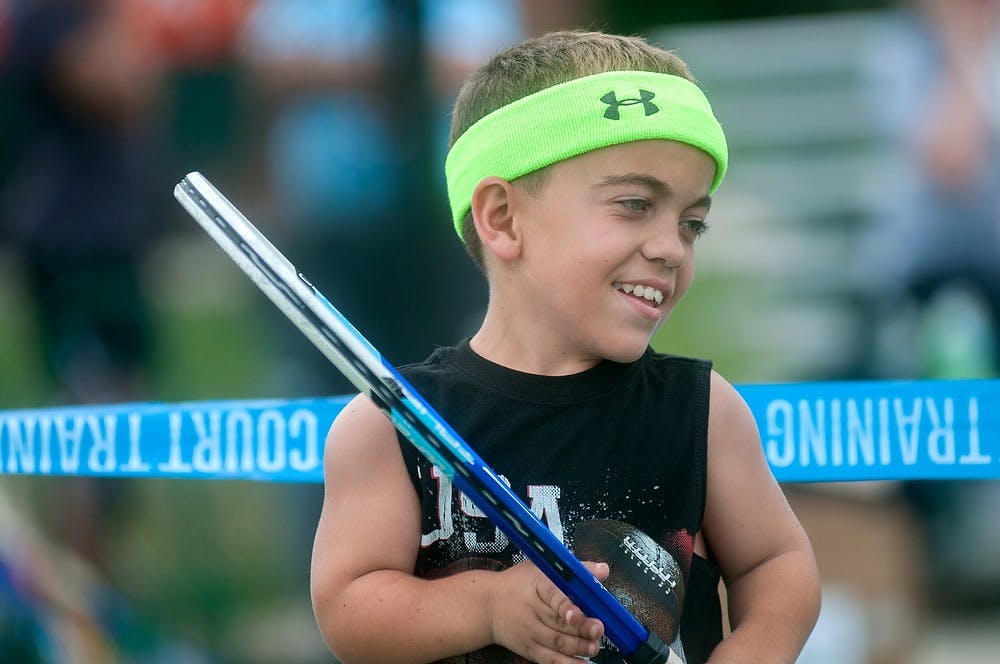 	<p>Daylen Harrison, 11, of Salem, Mo., waits in-between tennis games Aug. 6, 2013, during the World Dwarf Games at the tennis courts on Wilson Road. It was Harrison&#8217;s first time playing tennis. Weston Brooks/The State News</p>