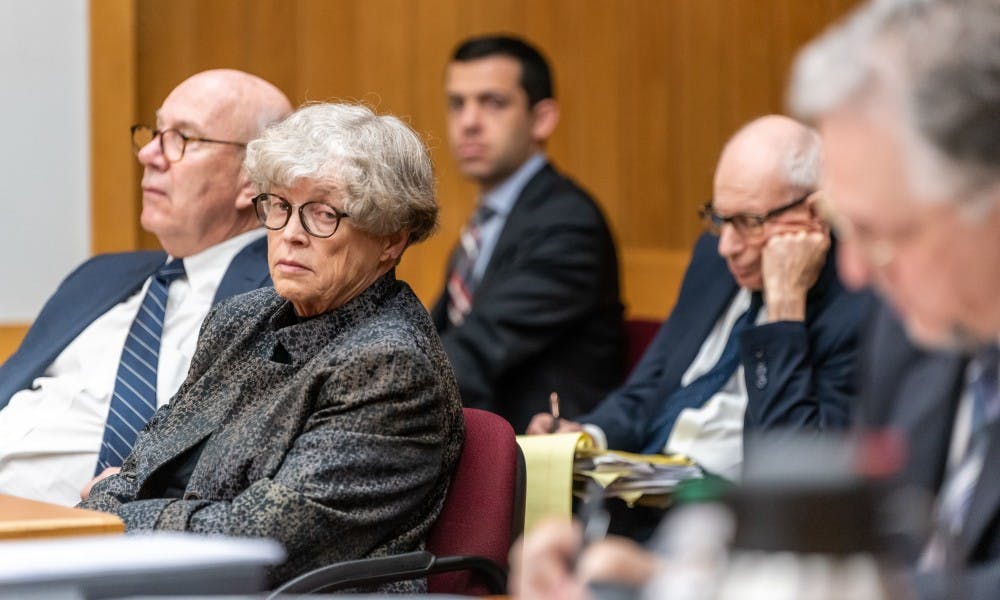 <p>Former MSU President Lou Anna K. Simon (second from left) looks over at Assistant Attorney General Scott Teter during her preliminary trial at the Eaton County courthouse on June 11, 2019. </p>