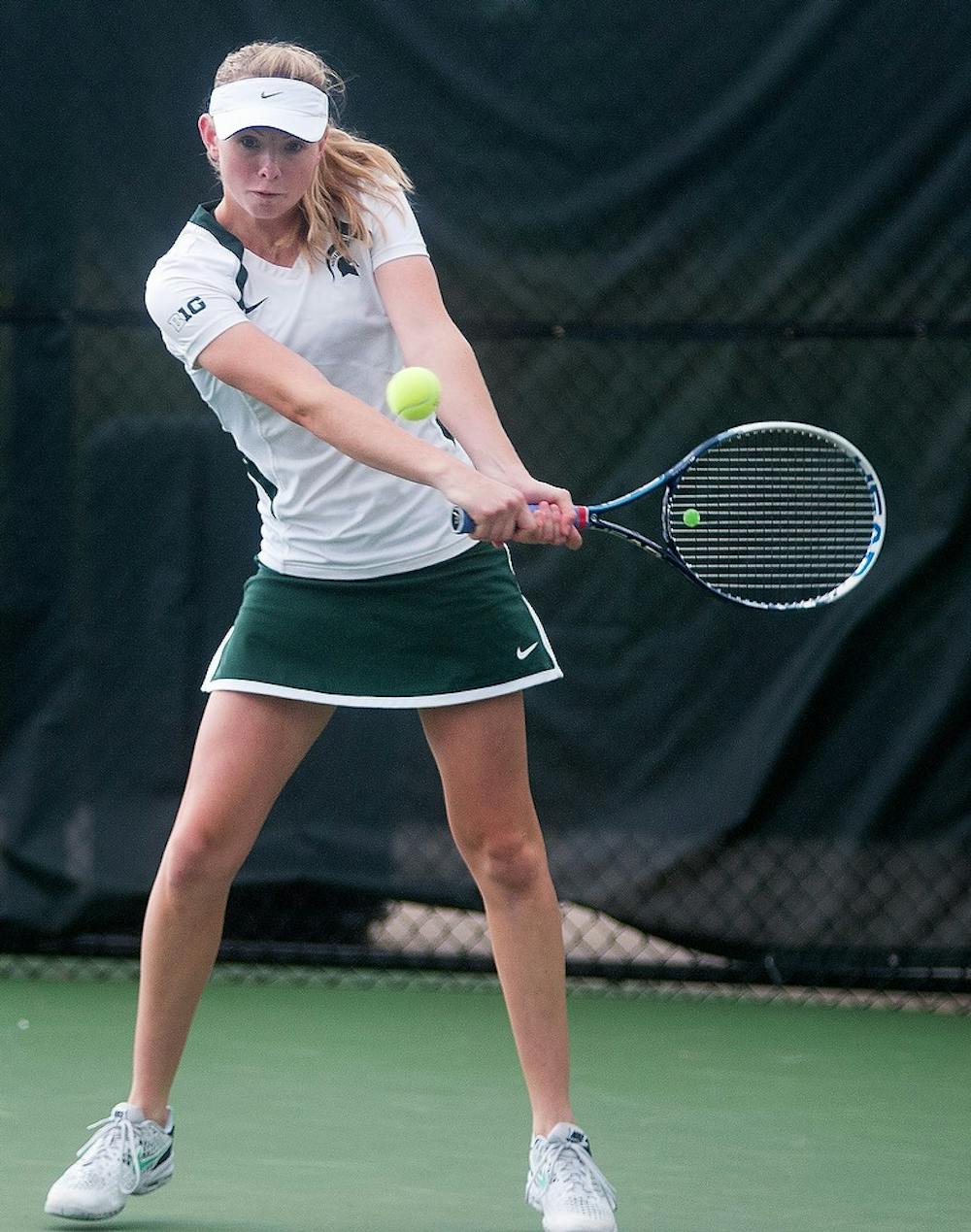 <p>Sophomore Erin Faulkner returns the ball Sept. 13, 2014, at the MSU Outdoor Tennis Courts on Wilson Road. Faulkner won her first match against IPFW player Mayu Satoin in three sets. Jessalyn Tamez/The State News </p>