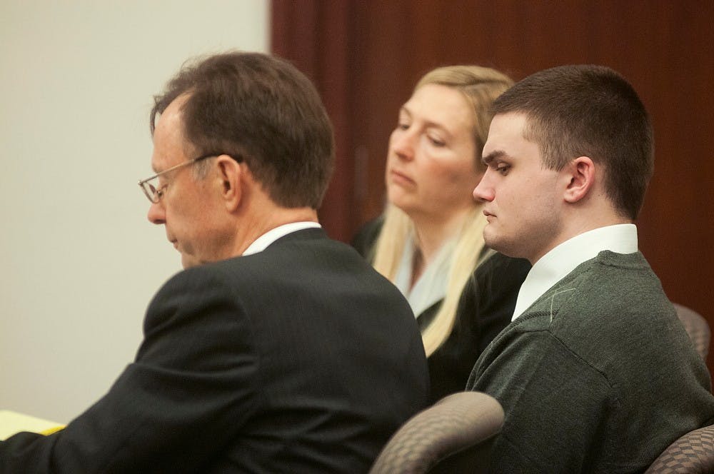 	<p>Okemos resident Connor McCowan listens to a recording of a 911 call placed by Tyler Aho during his trial, Oct. 1, 2013, in the Ingham County Circuit Court in Lansing. McCowan is being charged with open murder. Danyelle Morrow/The State News</p>