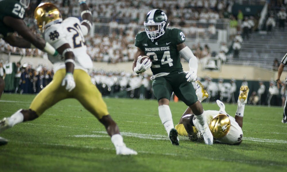 Senior running back Gerald Holmes rushes forward during the game against Notre Dame on Sept. 23, at Spartan Stadium. The Fighting Irish held a 28-7 lead at half.