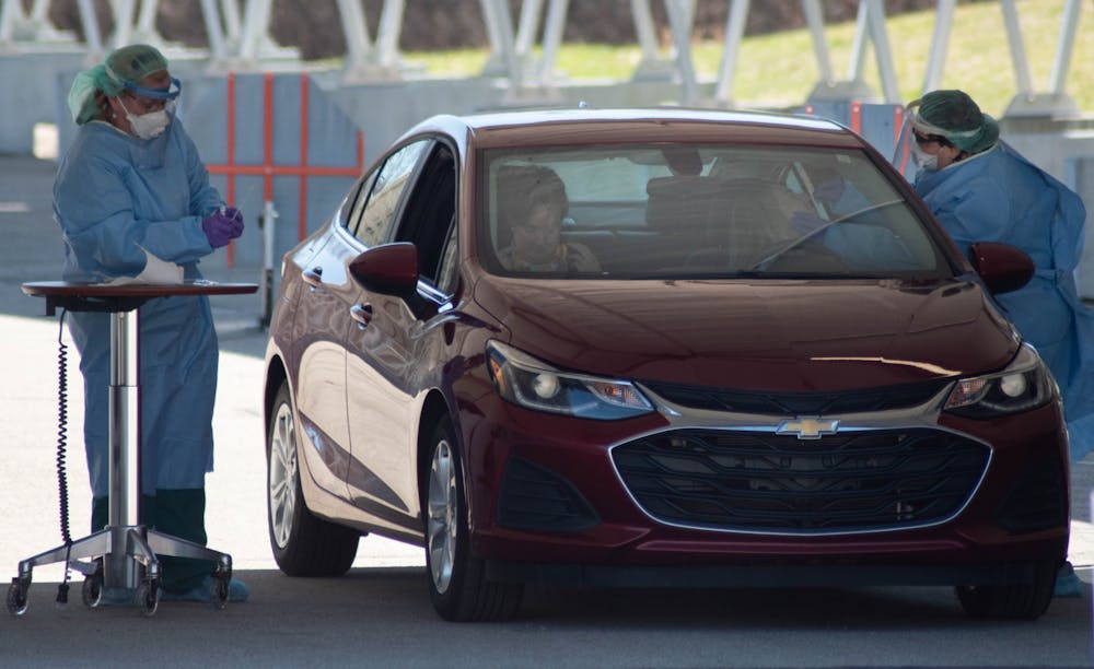 <p>Michigan State University Health Team members testing patients for COVID-19 at a drive-through testing site on April 2, 2020.</p>