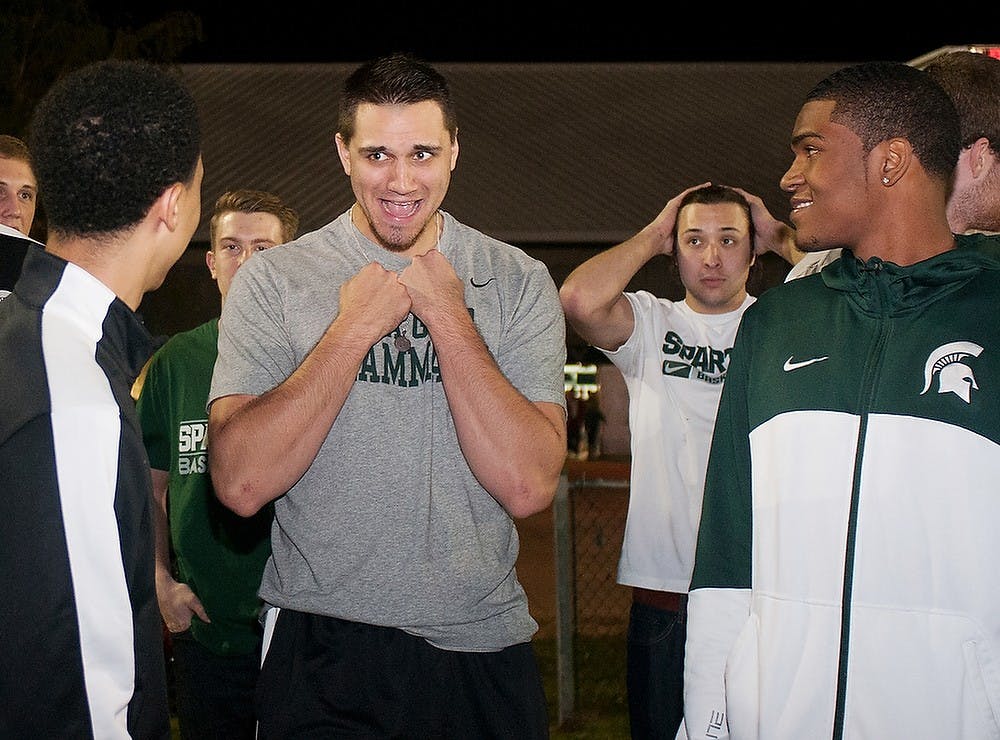 	<p>Junior guard Travis Trice, left, junior forward Alex Gauna, middle, and freshman forward Alvin Ellis, right, joke around on Sept. 27, 2013 at the Munn Intramural Field during the Izzone campout. Coach Izzo acknowledged this campout as the largest in the last few years. Georgina De Moya/The State News</p>