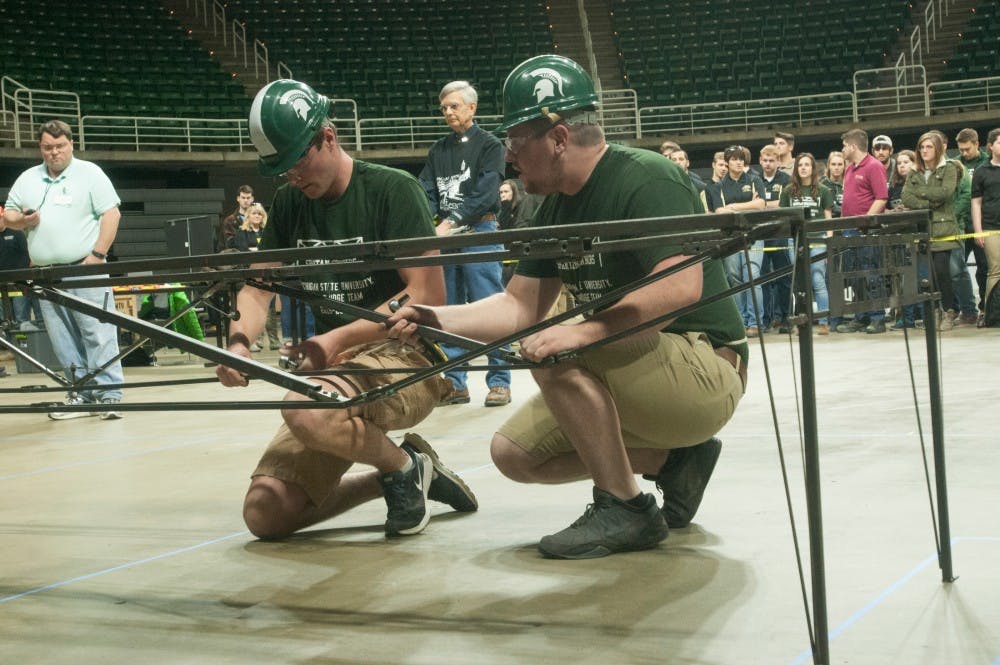 Mechanical engineering junior Shayne Maguire right, and civil engineering junior Kyle Savoie, left  prepares for the competition on April 8, 2016 at the Breslin Center. Michigan State University was one of nine schools competing in the steel bridge competition.