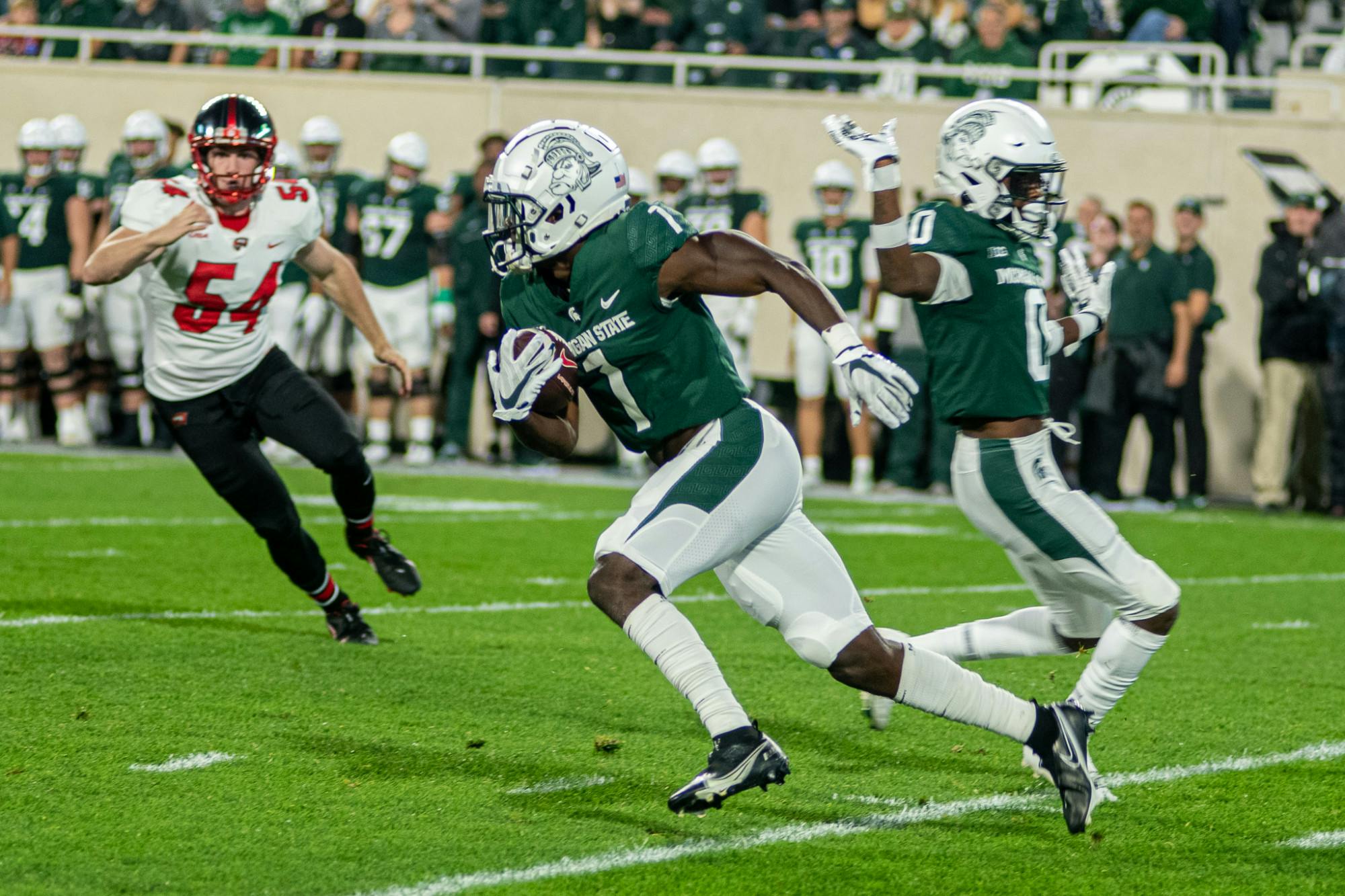 <p>Redshirt junior wide receiver Jayden Reed runs a punt return back for a touchdown on the first time the Spartans touched the ball. The Spartans dominated Western Kentucky in their homecoming game on Oct. 2, 2021</p>