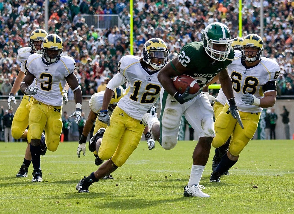 	<p>Freshman running back Larry Caper escapes tackles from Univeristy of Michigan defensemen and rushes into the endzone for the game-winning touchdown in overtime of Saturday&#8217;s 26-20 victory over U-M at Spartan Stadium. Caper ended the game with 39 rushing yards and 2 touchdowns. Sean Cook/The State News</p>