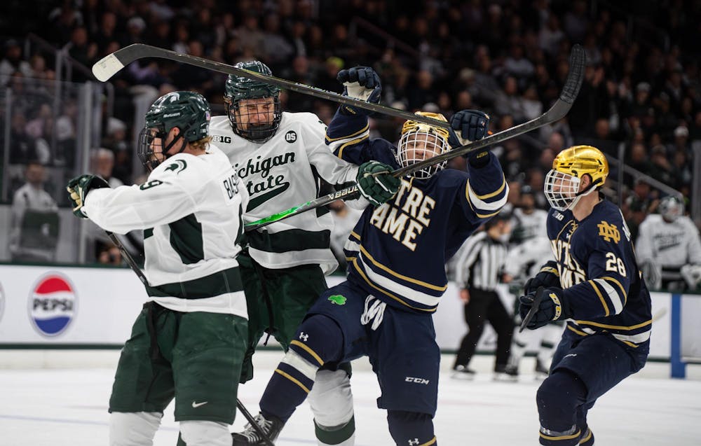 <p>Michigan State senior Matt Basgall (9), Michigan State sophomore Colin Ralph (4), Notre Dame junior Evan Werner (19) and Notre Dame graduate student Sutter Muzzatti (28) compete during a game at Munn Ice Arena in East Lansing, Michigan, on Friday, Feb. 20, 2026.</p>