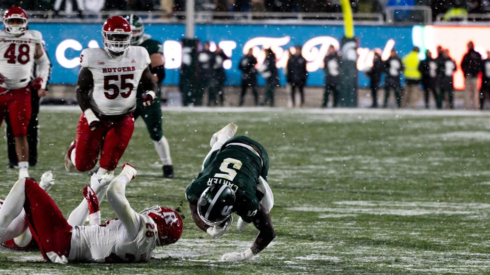 <p>MSU running back redshirt junior Nate Carter (5) gets tackled by Scarlet Knight linebacker junior Dariel Djabome (28) at Spartan Stadium on Nov. 30, 2024</p>