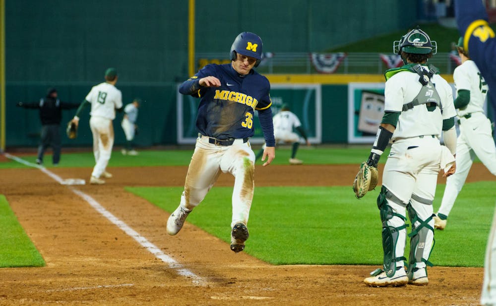 <p>Michigan sophomore Trevor Kilinski (36) runs home scoring another point for Michigan in the top of the ninth inning. Michigan State lost 18-6 to Michigan on April 15, 2022 at the Lugnut Stadium.</p>