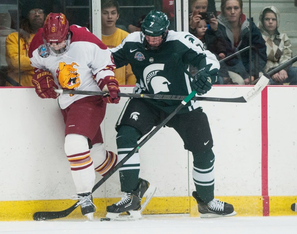 	<p>Freshman defenseman John Draeger battles Ferris State center Cory Kane for possession of the puck Jan. 5, 2013 at the Ewigleben Ice Arena in Big Rapids, Mich. The Bulldogs beat the Spartans 3-0. Julia Nagy/The State News</p>