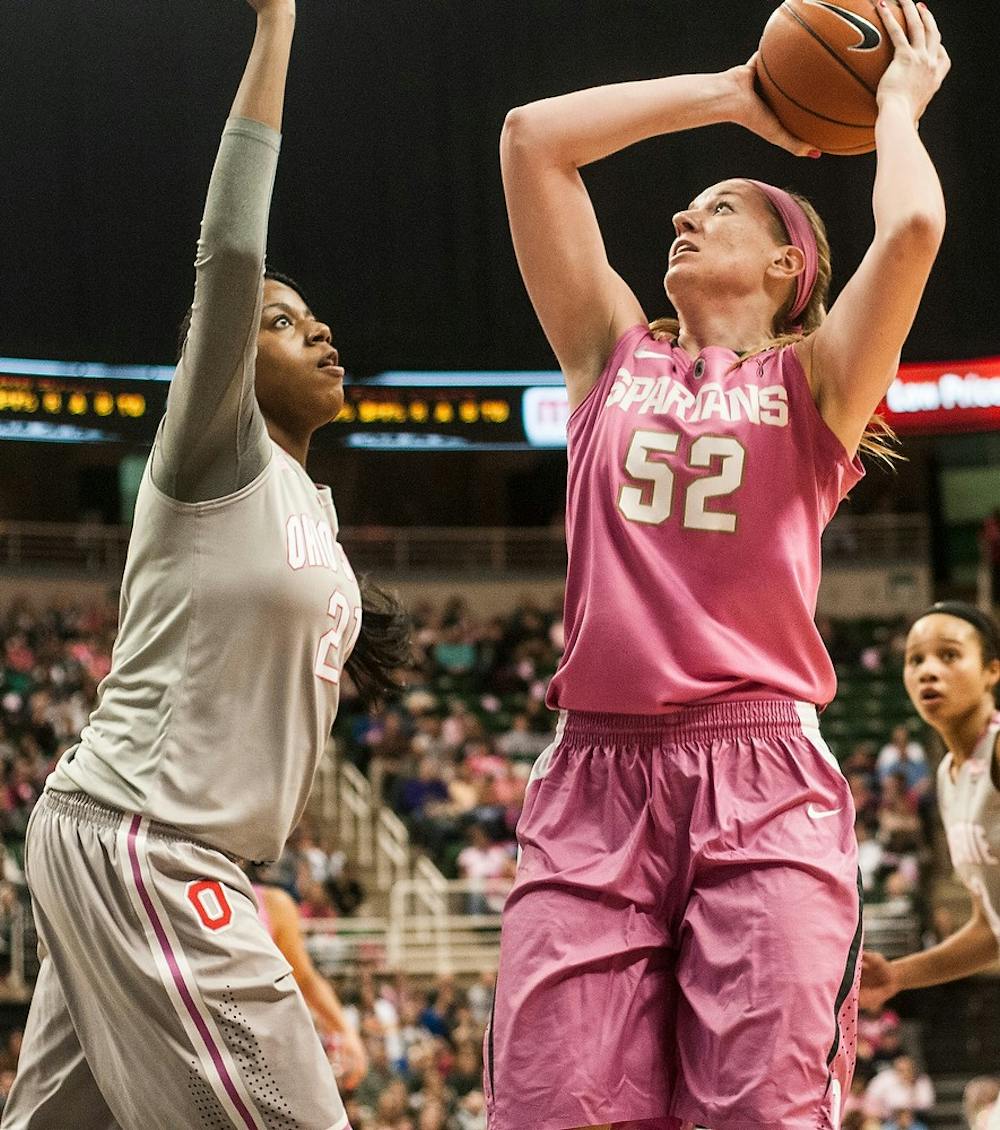 	<p>Junior forward Becca Mills shoots as Ohio State center Lisa Blair guards Feb. 15, 2014, at Breslin Center. The Spartans defeated the Buckeyes, 70-49. Erin Hampton/The State News</p>