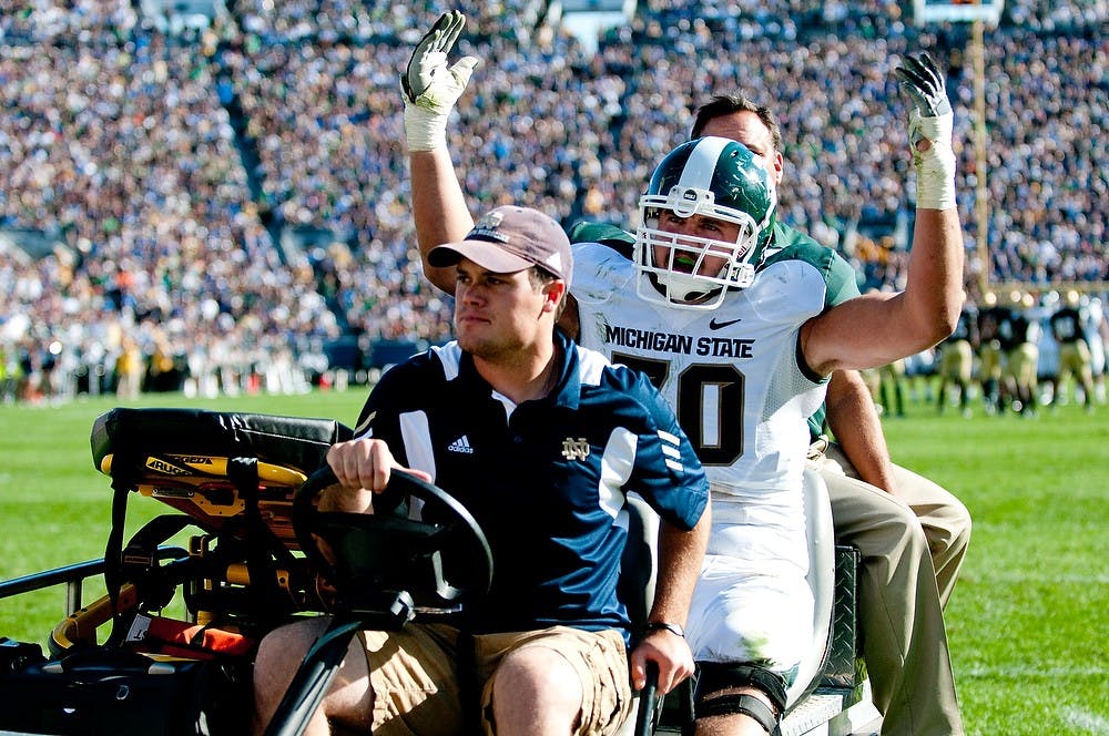 	<p>Then-redshirt freshman offensive tackle Skyler Burkland leaves the game after an injury in the first half in a game vs. the Fighting Irish in this photo dated 9/19/11. The Spartans lost to the Fighting Irish, 31-13 at Notre Dame Stadium in South Bend, Ind. State News File Photo </p>