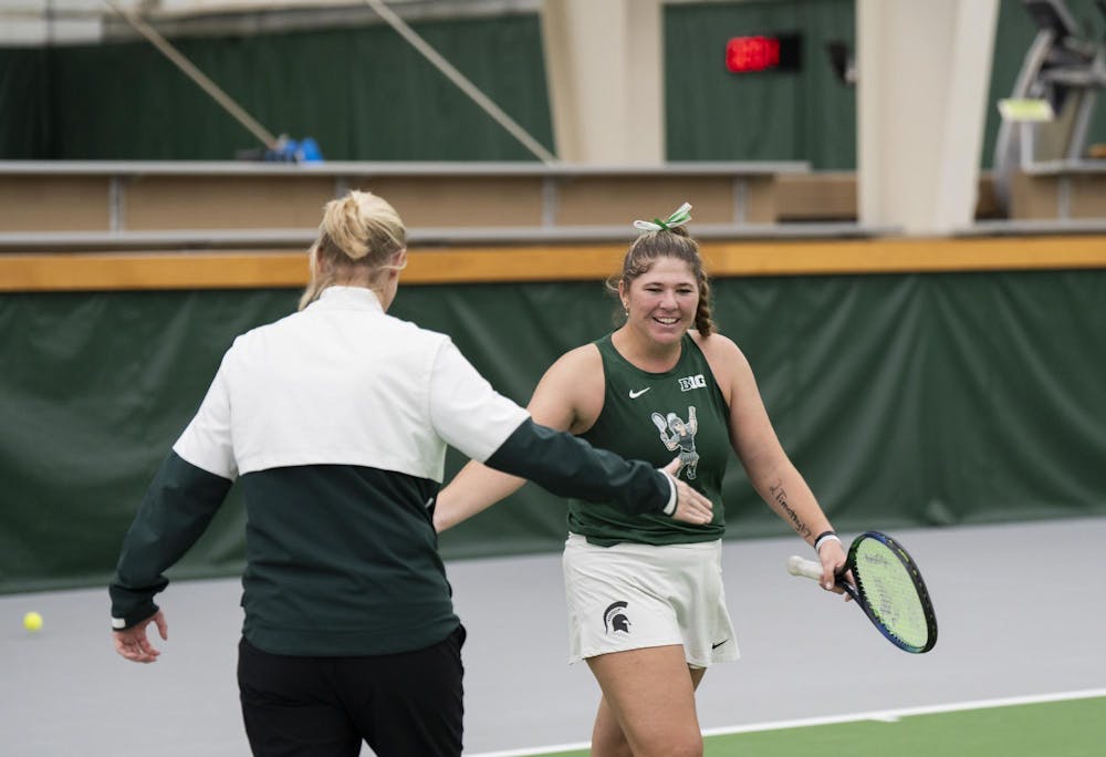 MSU grad student Nicole Conard celebrates her winning with the Lead Coach Kim Bruno against Purdue Junior Tara Katarina Milic at the MSU Tennis Facility on Mar. 30, 24.