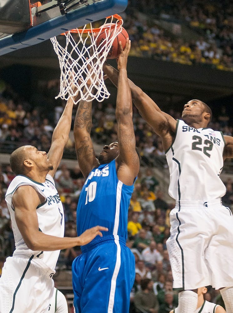 	<p>Junior center Adreian Payne, left, and sophomore guard / forward Branden Dawson defend Memphis forward Tarik Black in the first half of the game. The Spartans leads the Tigers during halftime, 32-29, Saturday, March 23, 2013, at The Palace of Auburn Hills in Auburn Hills, Mich. Justin Wan/The State News</p>