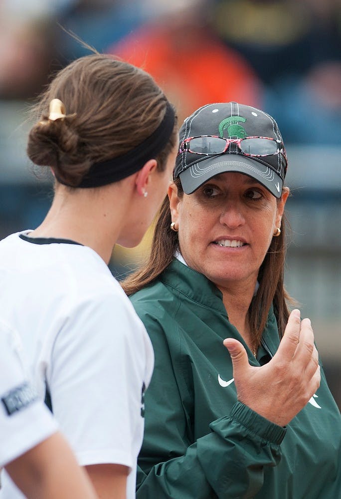 <p>Head coach Jacquie Joseph talks with junior catcher/outfielder Ellie Stoffer near the dugout during the game against Michigan on April 13, 2014, at Secchia Stadium at Old College Field. The Spartans were shut out by the Wolverines, 14-0. Danyelle Morrow/The State News</p>