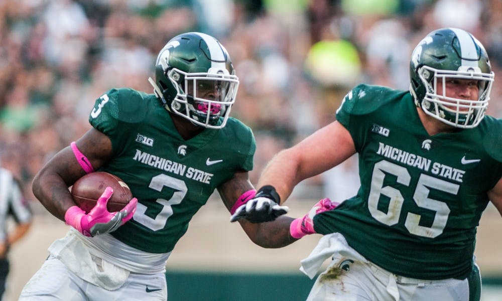 Junior running back LJ Scott (3) carries the football during the game against Indiana on Oct. 21, 2017, at Spartan Stadium. The Spartans defeated the Hoosiers, 17-9.