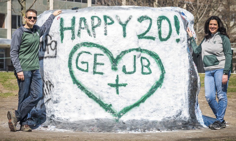 Glenn Eyre and Jenny Eyre pose for a picture on April 1, 2017 at the Rock on Farm Lane. Glenn Eyre painted the rock to surprise Jenny Eyre for their 20th anniversary which is on April 4. 