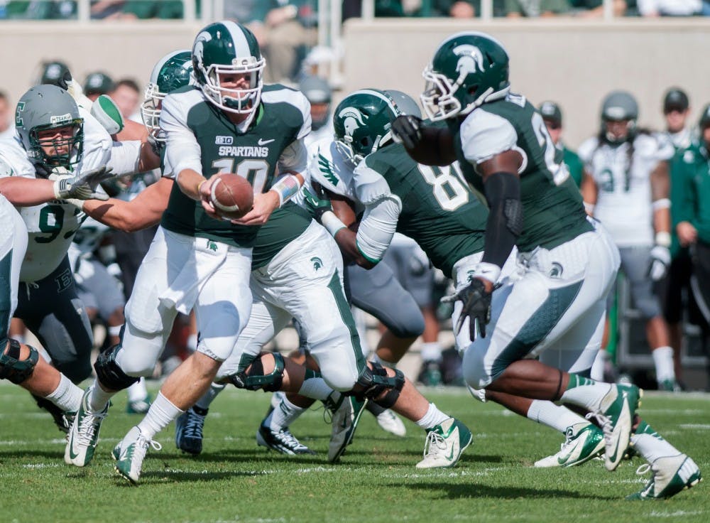 Junior quarterback Andrew Maxwell goes to hand the ball off on Saturday afternoon, Sept. 22, 2012, at Spartan Stadium. The Spartans took on the Eagles and won 23-7. Natalie Kolb/The State News