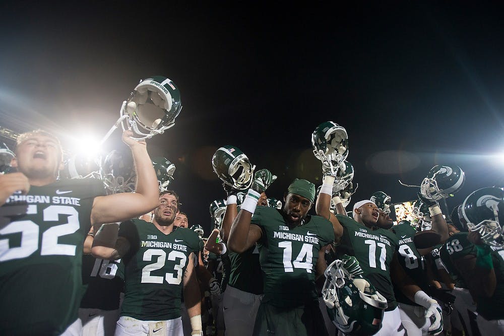 <p>The Spartans celebrate after the game against Jacksonville State on Aug. 29, 2014, at Spartan Stadium. The Spartans defeated the Gamecocks, 45-7. Julia Nagy/The State News</p>