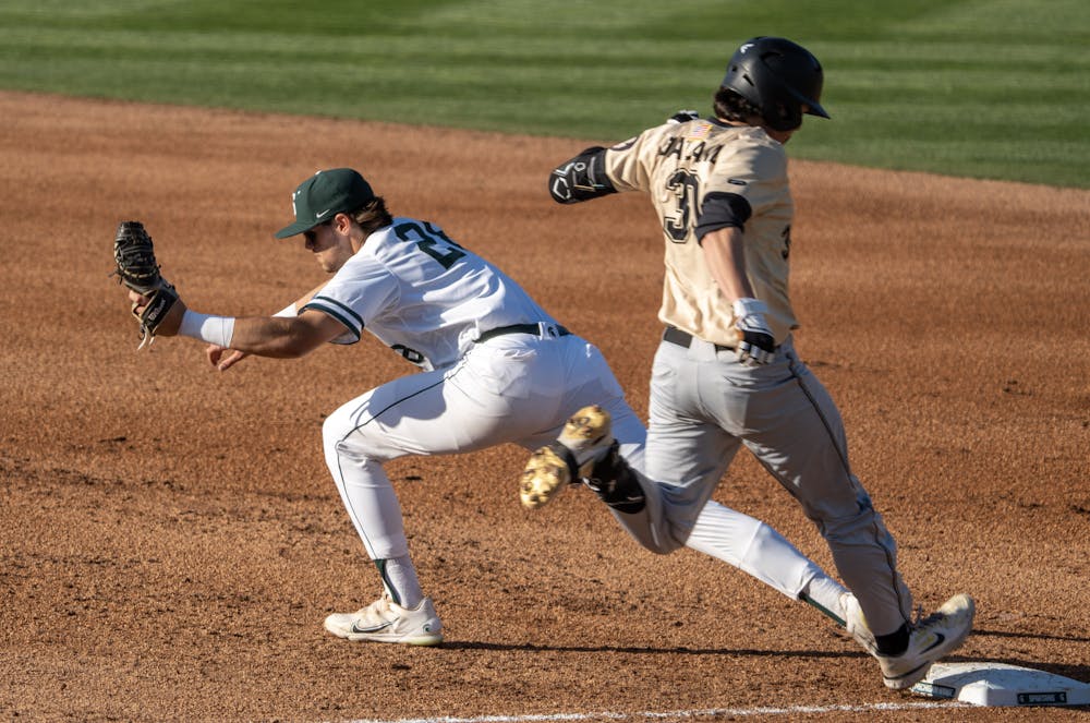 <p>Michigan State First Baseman Brock Vradenburg stretches out to make the out against Oakland on April 12, 2023 at McLane Stadium.</p>