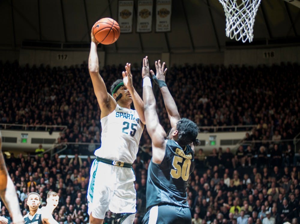 Red-shirt sophomore Kenny Goins (25) shoots the ball as Purdue forward Caleb Swanigan (50) defends him during the second half of the men's basketball game against Purdue on Feb. 18, 2017 at Mackey Arena in Lafayette, Ind. The Spartans were defeated by the boilermakers, 80-63.