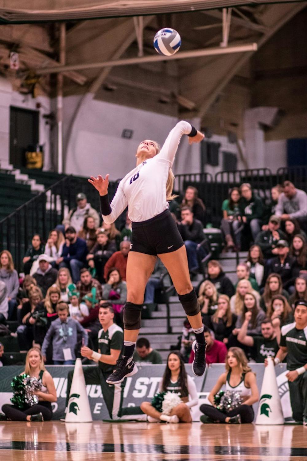 Senior outside hitter Holly Tolliver (18) serves a ball during the game against Indiana on November 18, 2017, at Jenison Fieldhouse. The Spartans defeated the Hoosiers, 3-0.