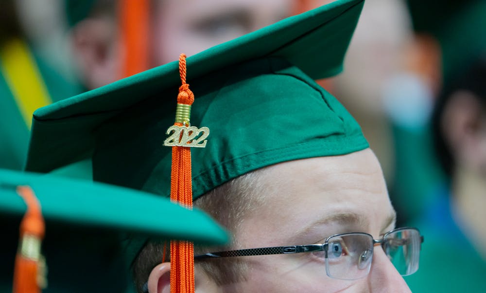 A graduate of the College of Engineering listens to speakers during the commencement ceremony in the Breslin Student Events Center on Dec. 17, 2022.