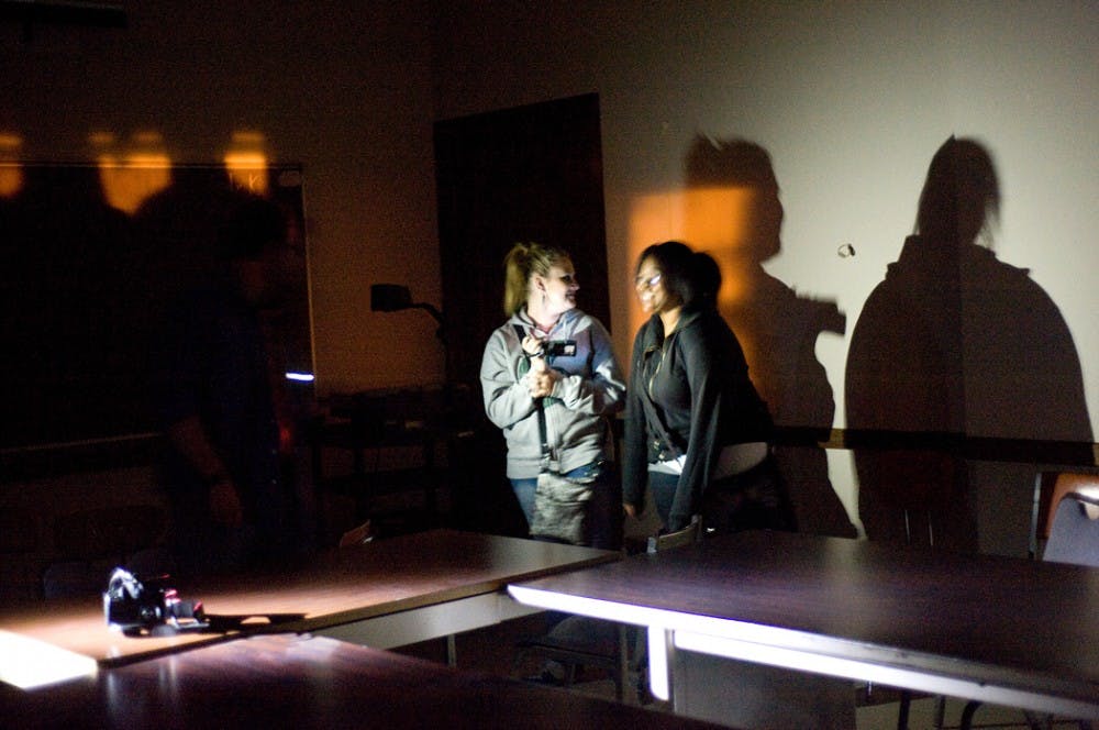 Zoology freshman Jennifer Wilson, left, uses a video recorder to detect paranormal activity on Saturday night inside Morill Hall with no-preference freshman Porsha Wyatt. Sponsored by University Activities Board, the event work with MSU paranormal society to look for activities inside Morill Hall. Justin Wan/The State News