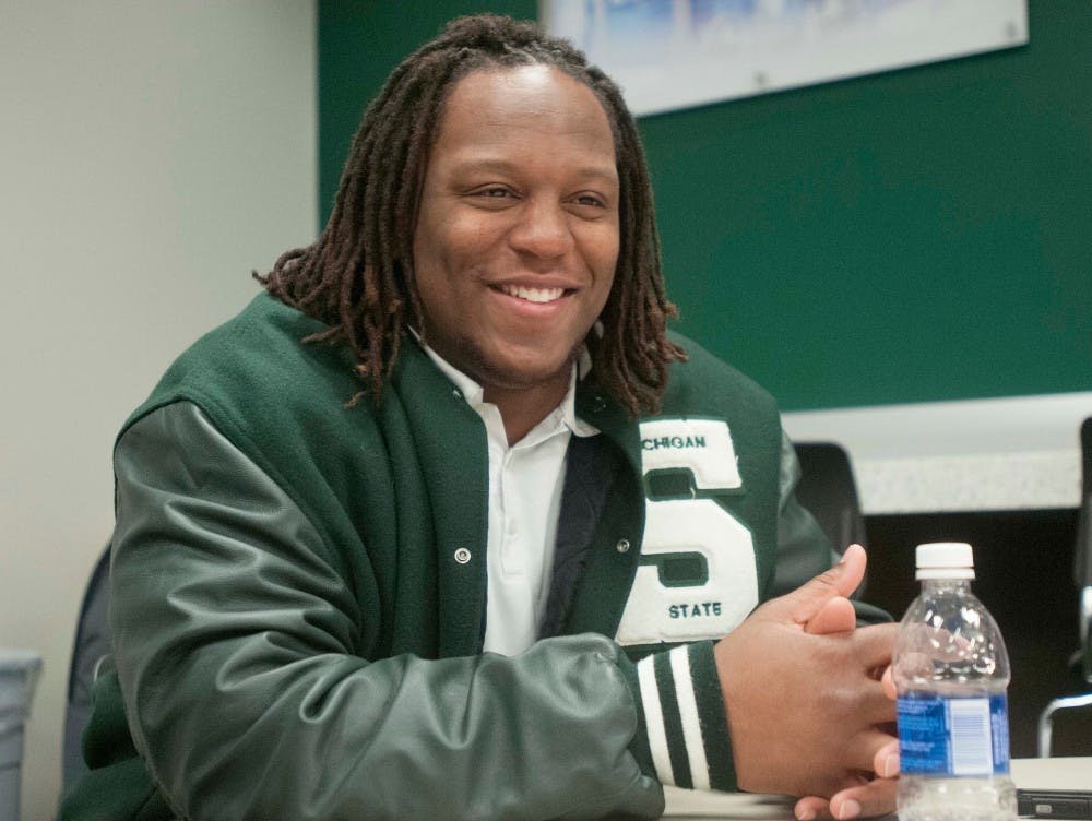 Senior offensive lineman Donavon Clark chuckles after a question is asked during a Cotton Bowl media conference on Dec. 16, 2015 at Spartan Stadium. Select members of the MSU football team answered questions posed by numerous media outlets regarding the upcoming Cotton Bowl against Alabama.