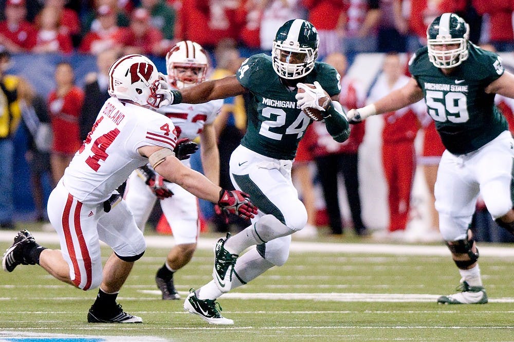 Then-sophomore running back Le'Veon Bell stiff arms Wisconsin linebacker Chris Borland during the Wisconsin game Dec. 03, 2011, at Lucas Oil Stadium in Indianapolis, Ind. The Spartans lost to the Wisconsin Badgers, 42-39, in the Big Ten Championship game. State News File Photo.