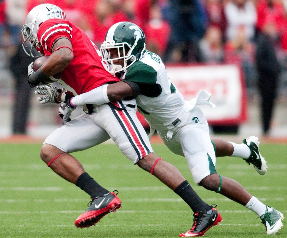 Sophomore cornerback Darqueze Dennard tackles Ohio State wide receiver Verlon Reed. Dennard had four tackles and an interception in the Spartans' 10-7 victory Ohio State on Saturday afternoon at Ohio Stadium in Columbus, Ohio. Josh Radtke/The State News