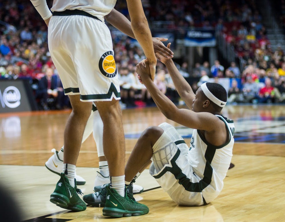 Teammates help junior guard Cassius Winston (5) to his feet during the NCAA tournament game against Bradley at Wells Fargo Arena March 21, 2019. The Spartans defeated the Braves, 76-65.