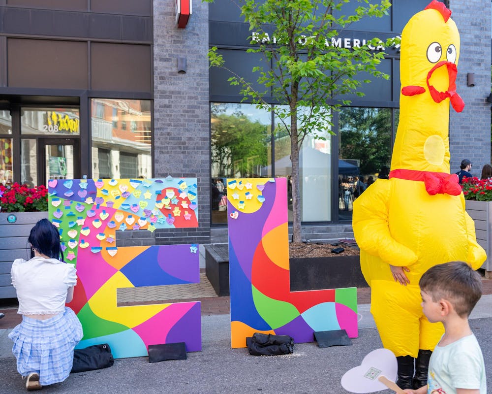<p>The Dave's Hot Chicken, "drag chicken" interacts with attendees of East Lansing Pride on Albert Ave in East Lansing, Mich., on June 13, 2026.</p>