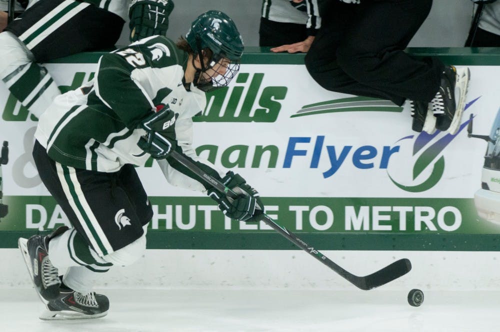 <p>Sophomore forward JT Stenglein dribbles the puck down the ice rink during the game against Minnesota Dec. 5, 2014 at Munn Ice Arena. The Spartans were defeated by the Gophers, 5-0. Jessalyn Tamez/The State News </p>