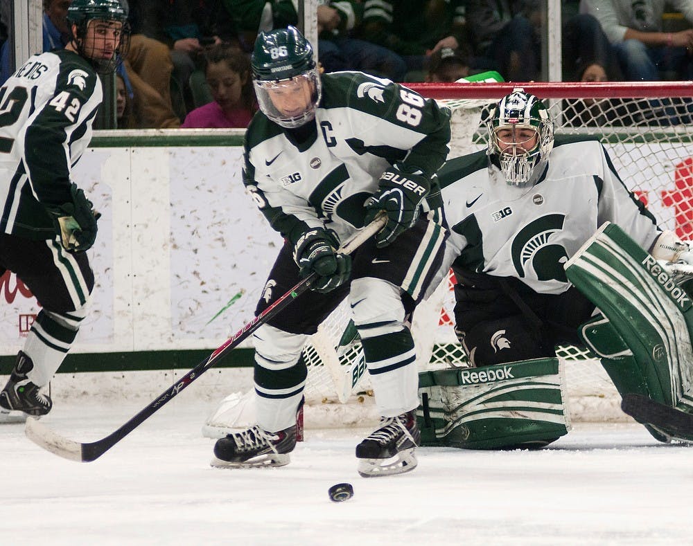 	<p>Senior forward Greg Wolfe skates the puck away from the Spartan net during the game against Minnesota on Dec. 6, 2013, at Munn Ice Arena. The Spartans tied the game with the Golden Gophers, 2-2, but won the shootout. Danyelle Morrow/The State News</p>