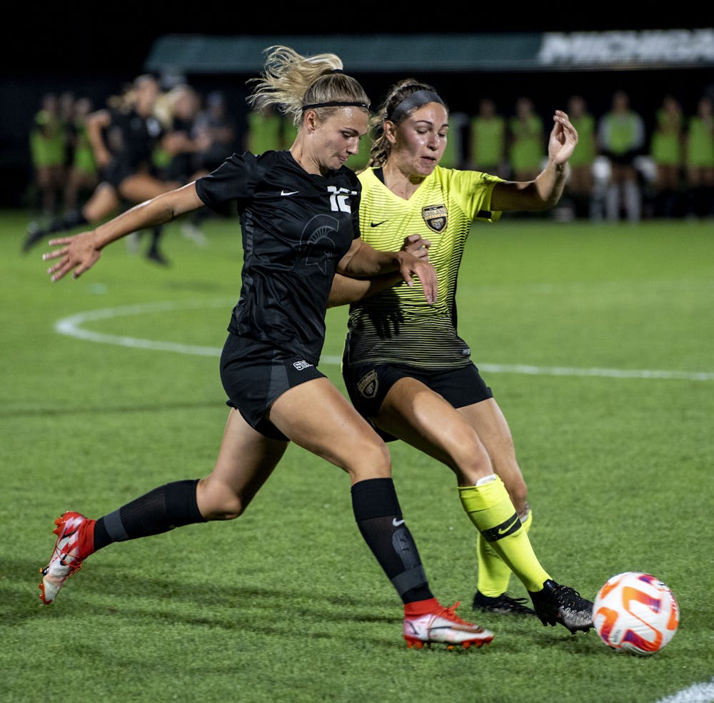 <p>Sophomore forward Jordyn Wickes (12) and Oakland’s Kendra Zak (2) face off during a MSU and Oakland women’s soccer game at DeMartin Field in East Lansing on Sept. 8, 2022. The Spartans and Grizzlies tied, 0-0.</p>