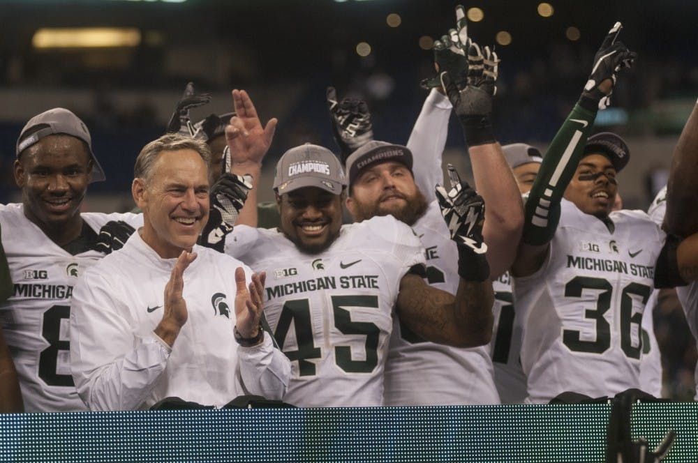 The Spartans celebrate on Dec. 5, 2015 after the Big Ten championship game against Iowa at Lucas Oil Stadium in Indianapolis. The Spartans defeated the Hawkeyes, 16-13.