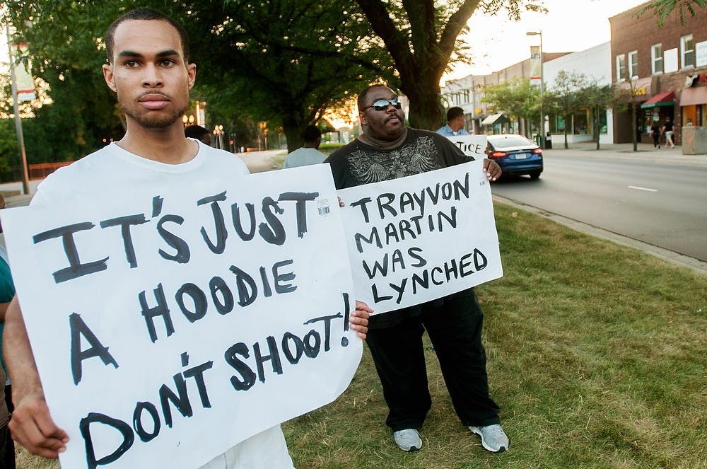 	<p>Journalism senior Tyler Clifford, left, and graduate student Joseph Harris hold signs protesting the verdict of the Trayvon Martin case, July 14, 2013, on Grand River Avenue. &#8220;Some people have the luxury to ignore this, but I feel like I can&#8217;t,&#8221; Harris said.</p>