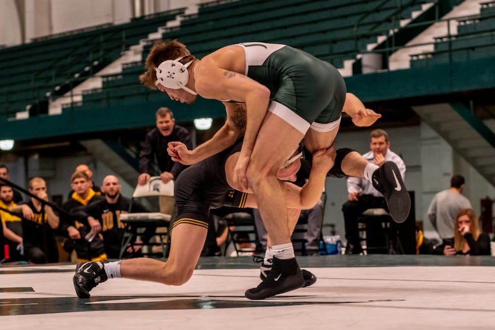<p>Then-junior Jake Tucker wrestles Iowa’s Kaleb Young. Young defeated Tucker 6-2 at Jenison Field House on Feb. 2, 2020. </p>