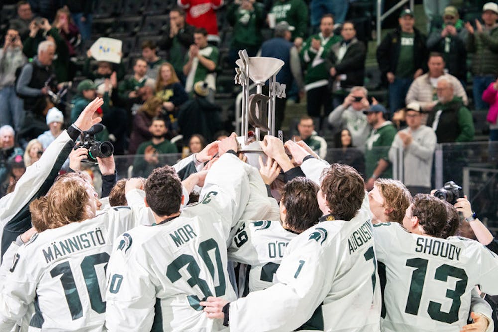 <p>The Michigan State men's ice hockey team celebrates with the Duel in the D trophy after the annual battle between the in-state rivals. </p>