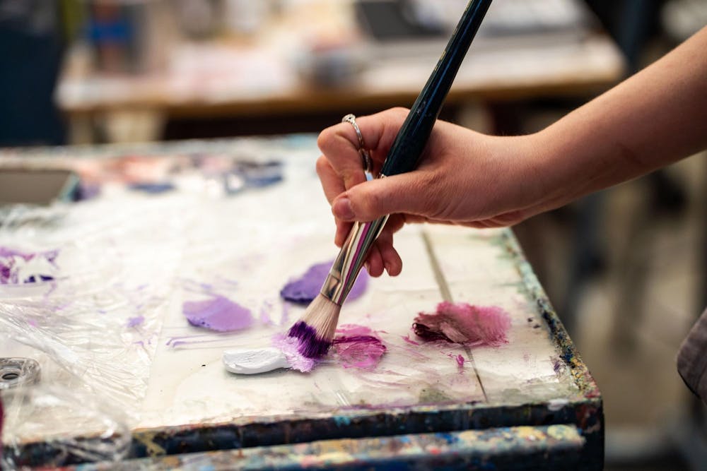Fourth-year Michigan State studio art student Evan Yalowitz paints in her studio within the Kresge Art Center on April 4, 2025. The Kresge Art Center, located on Auditorium Road, serves as the home for the Department of Art, Art History, and Design, providing dedicated studio spaces for students to develop their artistic practices 