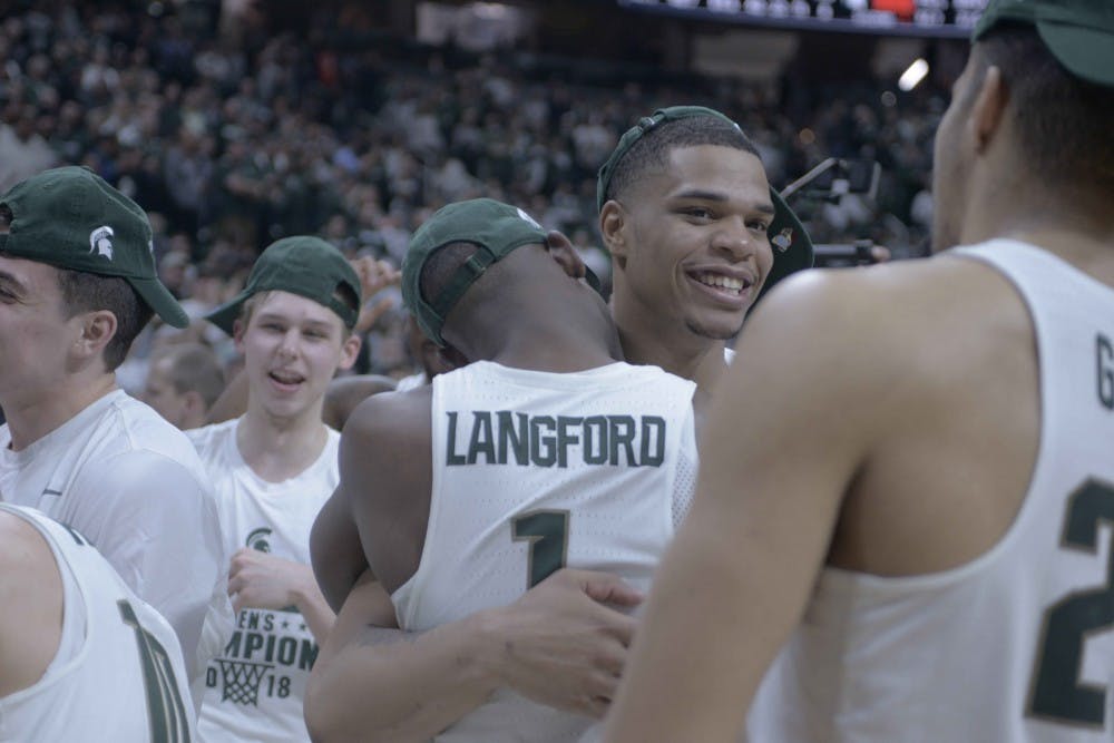 Sophomore forward and guard Miles Bridges (22) hugs teammate sophomore guard Joshua Langford (1) after the game against Illinois on Feb. 20, 2018 at Breslin Center. The Spartans defeated Illinois 81-61 and were crowned the 2018 Big Ten Champions. (Annie Barker | The State News)