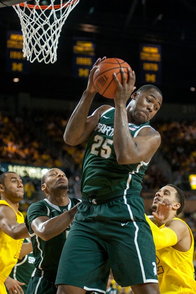 Senior center Derrick Nix goes up to grab a defensive rebound in the first half of the game. The Wolverines defeated the Spartans, 58-57, March 3, 2013, at Crisler Center in Ann Arbor, Mich. Justin Wan/The State News