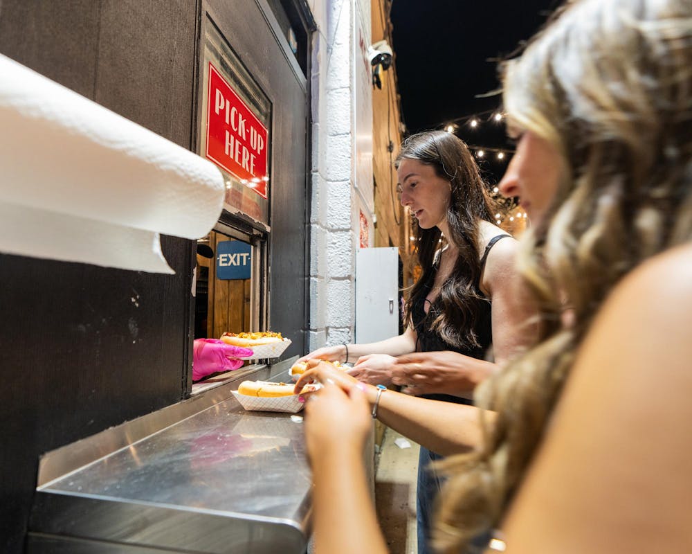 <p>Michigan State University students receive their hot dogs from a University Weiner employee in East Lansing, MI on April 17, 2026.</p>