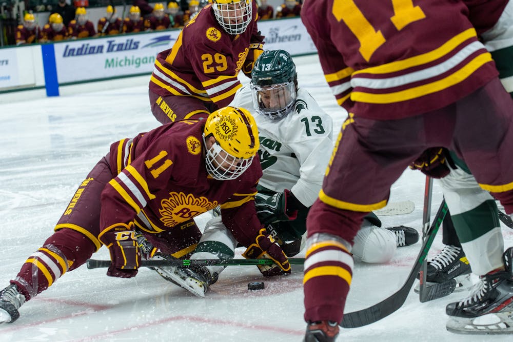 <p>Feb 14.- East Lansing- Michigan State Univeristy hockey player, Kristof Papp (13) during a face-off with Arizona State Univeristy hockey player Benji Eckerle (11).</p>