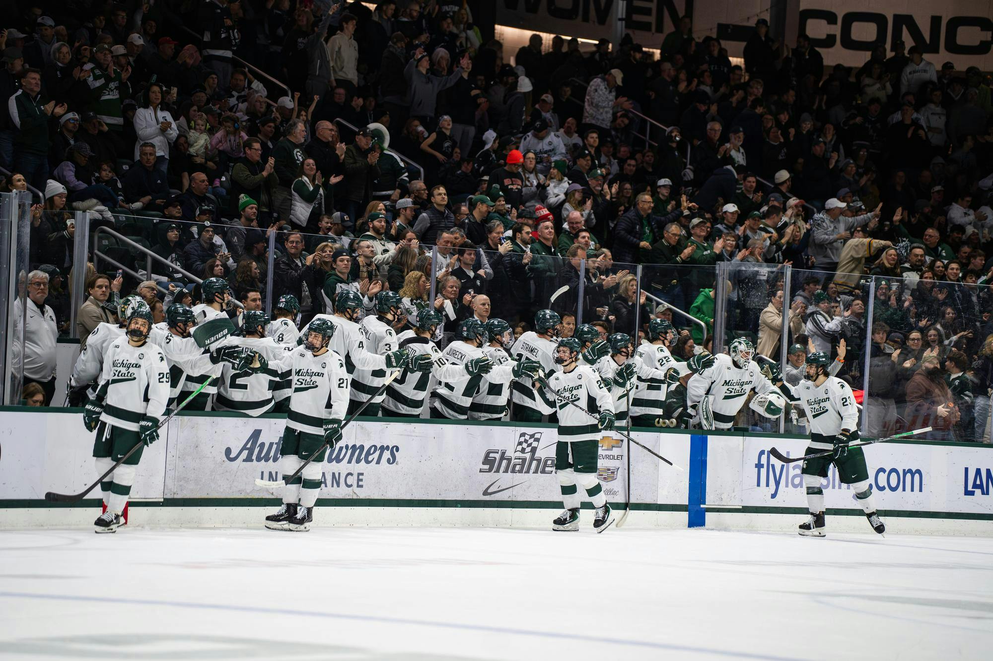 <p>Michigan State hockey players on the bench high-five teammates on the ice after scoring a point for the Michigan State University hockey team at Munn Ice Arena in East Lansing, Michigan, on Friday, Feb. 20, 2026.</p>