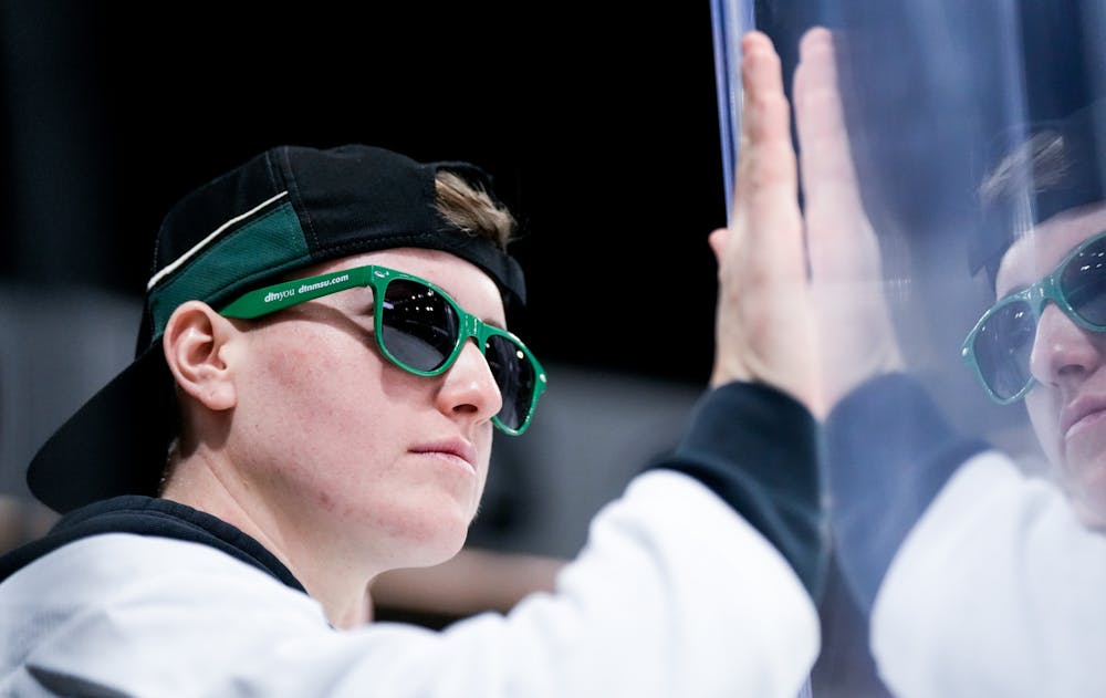 <p>An MSU fan bangs on the glass to cheer for the men's hockey team during a game against Notre Dame at Munn Ice Arena on Feb. 3, 2023. The Spartans defeated the Fighting Irish 3-0.</p>